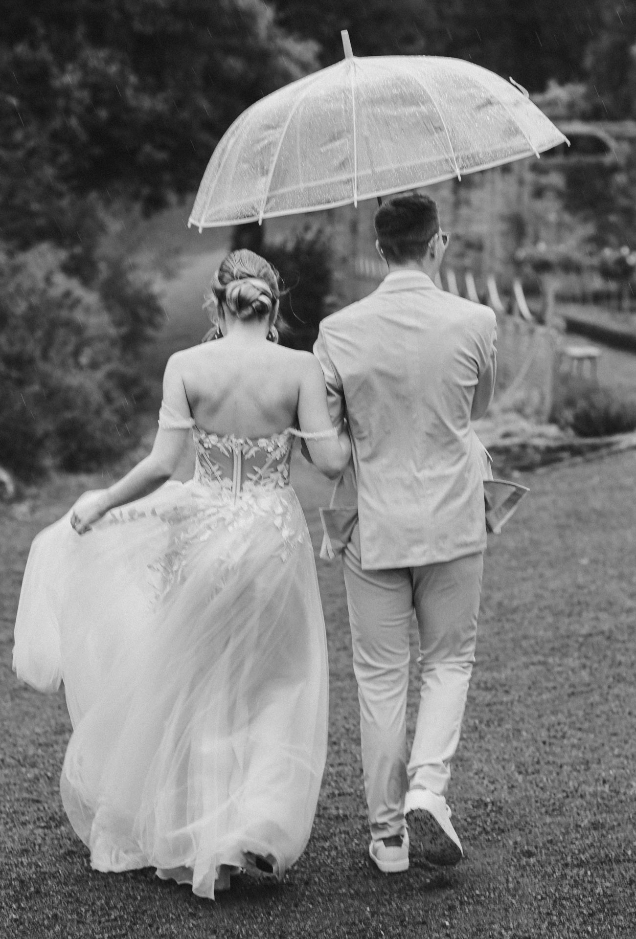 Brautpaar lacht entspannt beim Paarshooting im Schlosspark Ettersburg bei Regen. Danach elegante Paarfotos und romantische Schleierportraits im Weißen Saal.
